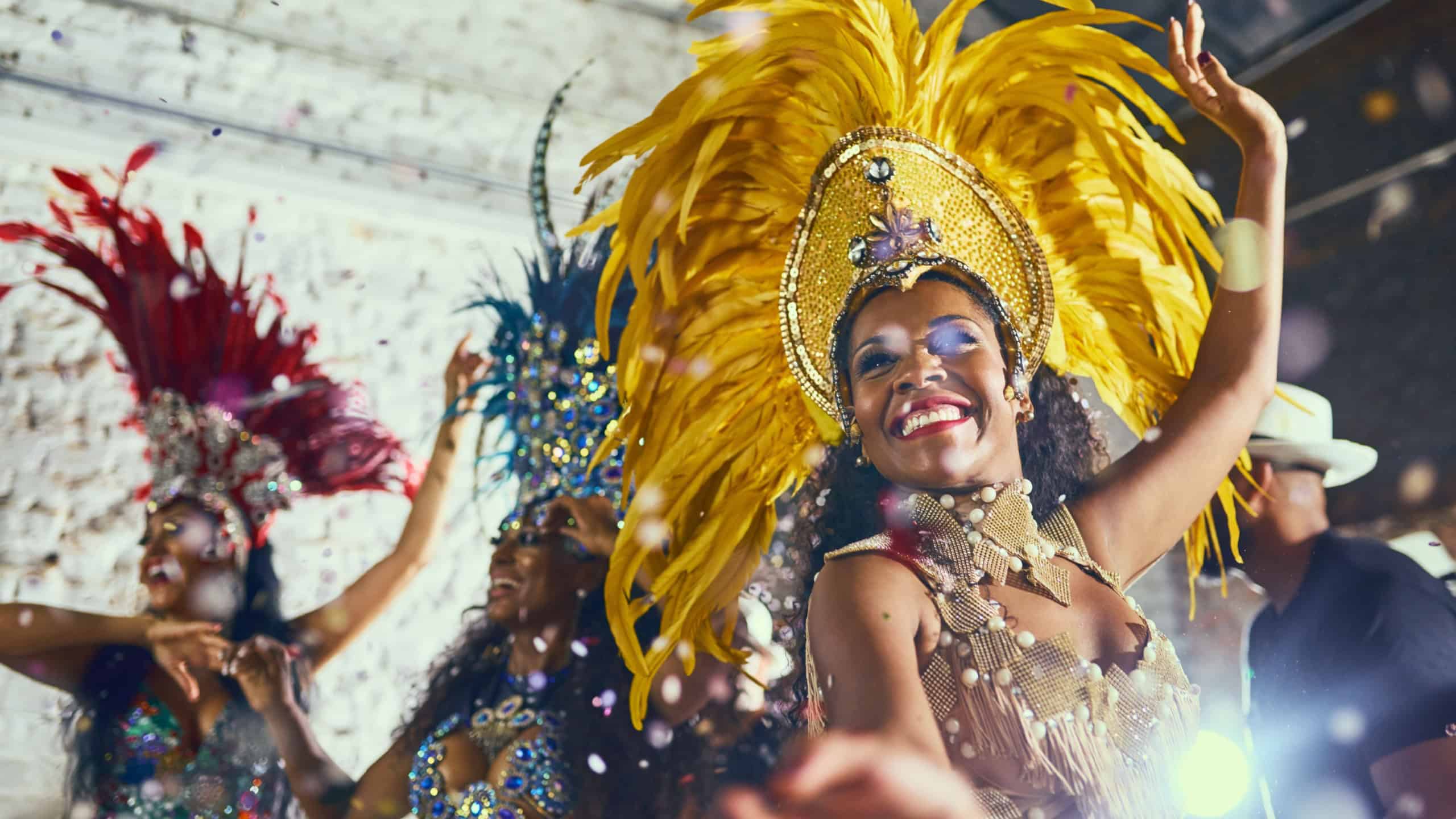 Carnival, performance and woman with samba for dance, parade and event in Brazil. Happiness, female dancer and celebration in city with creative fashion, confetti and music for tradition and culture