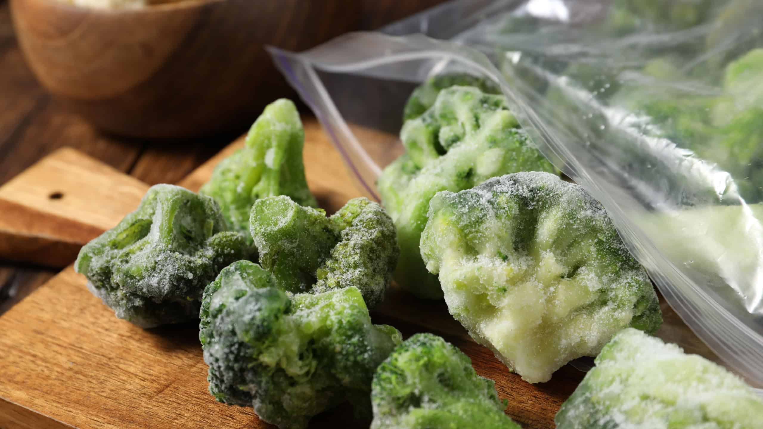 Frozen broccoli out of plastic bag on table, closeup