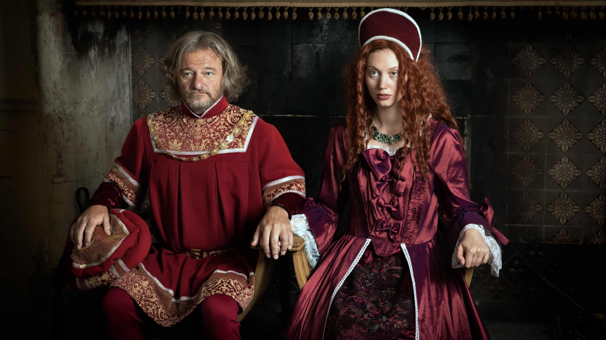Medieval Renaissance king and queen in Tudor style costumes reenactment in a French castle