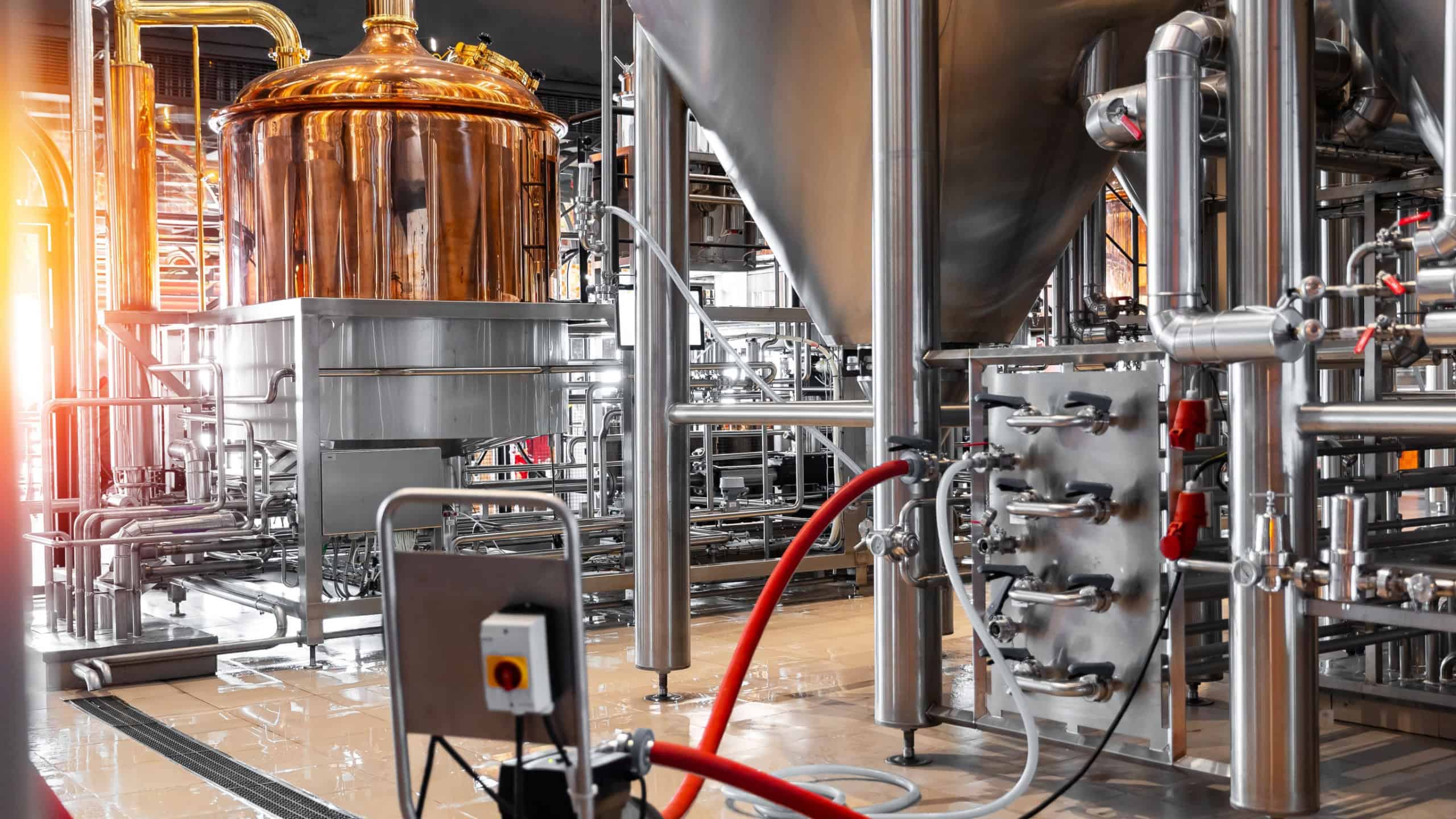 Pipes stainless steel brewing equipment, Brewery food industrial production concept. Large reservoirs or tanks in modern beer factory.