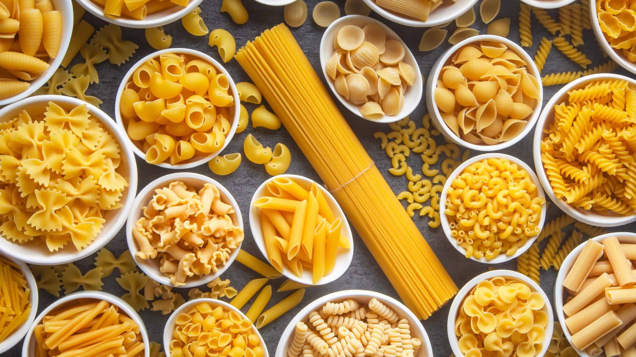 Composition with different tasty uncooked pasta - Italian pasta wallpaper, different types and shapes of pasta layout