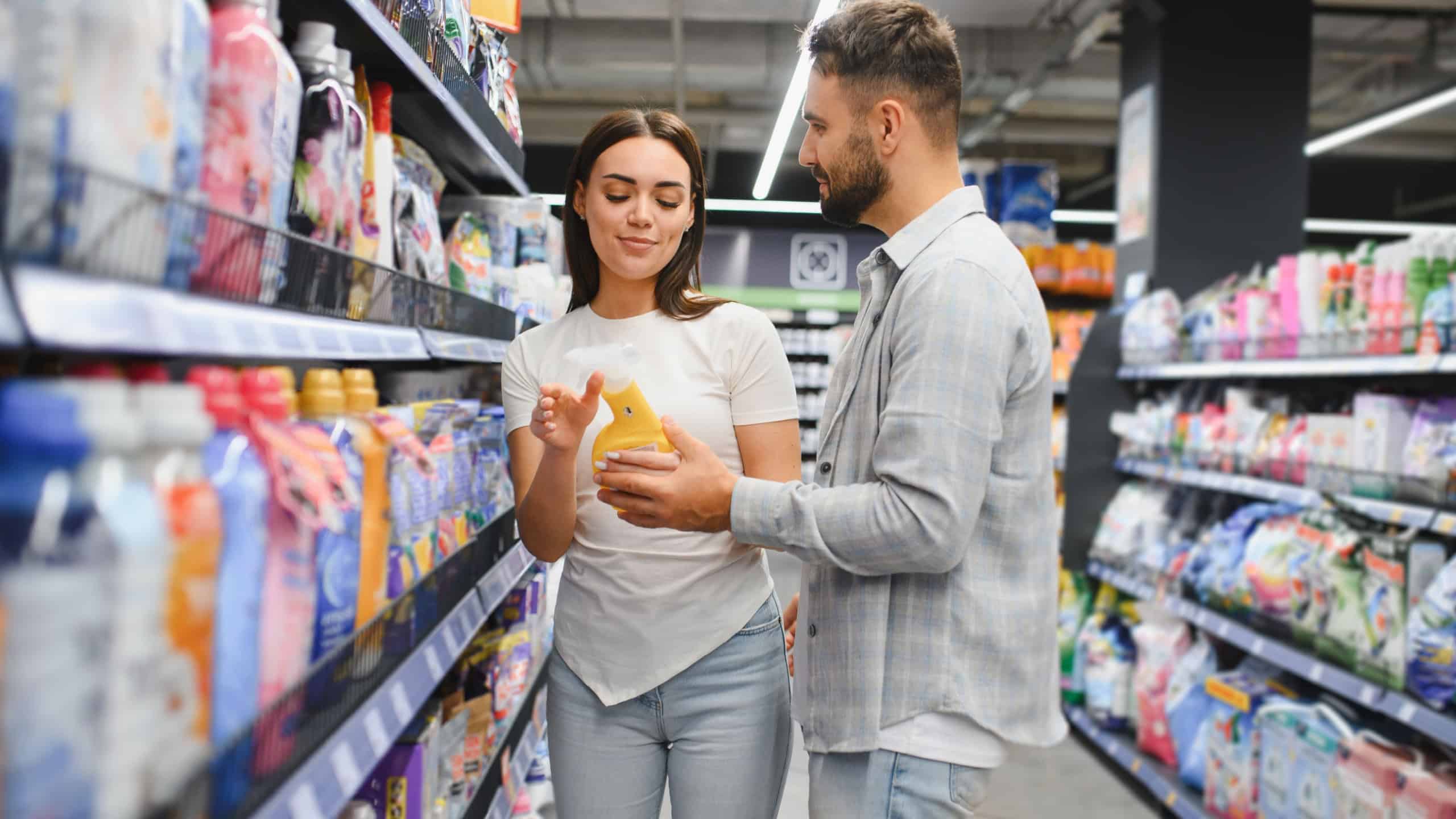 People shopping for household chemicals in a grocery store, making purchasing decisions, focusing on consumer products