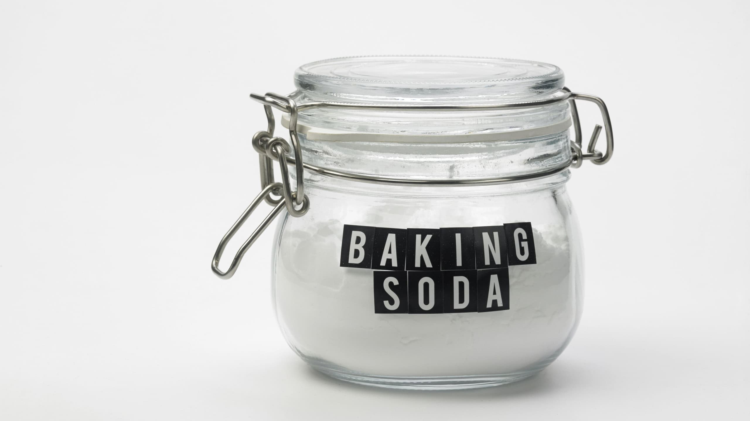 Jar of baking soda on the white background