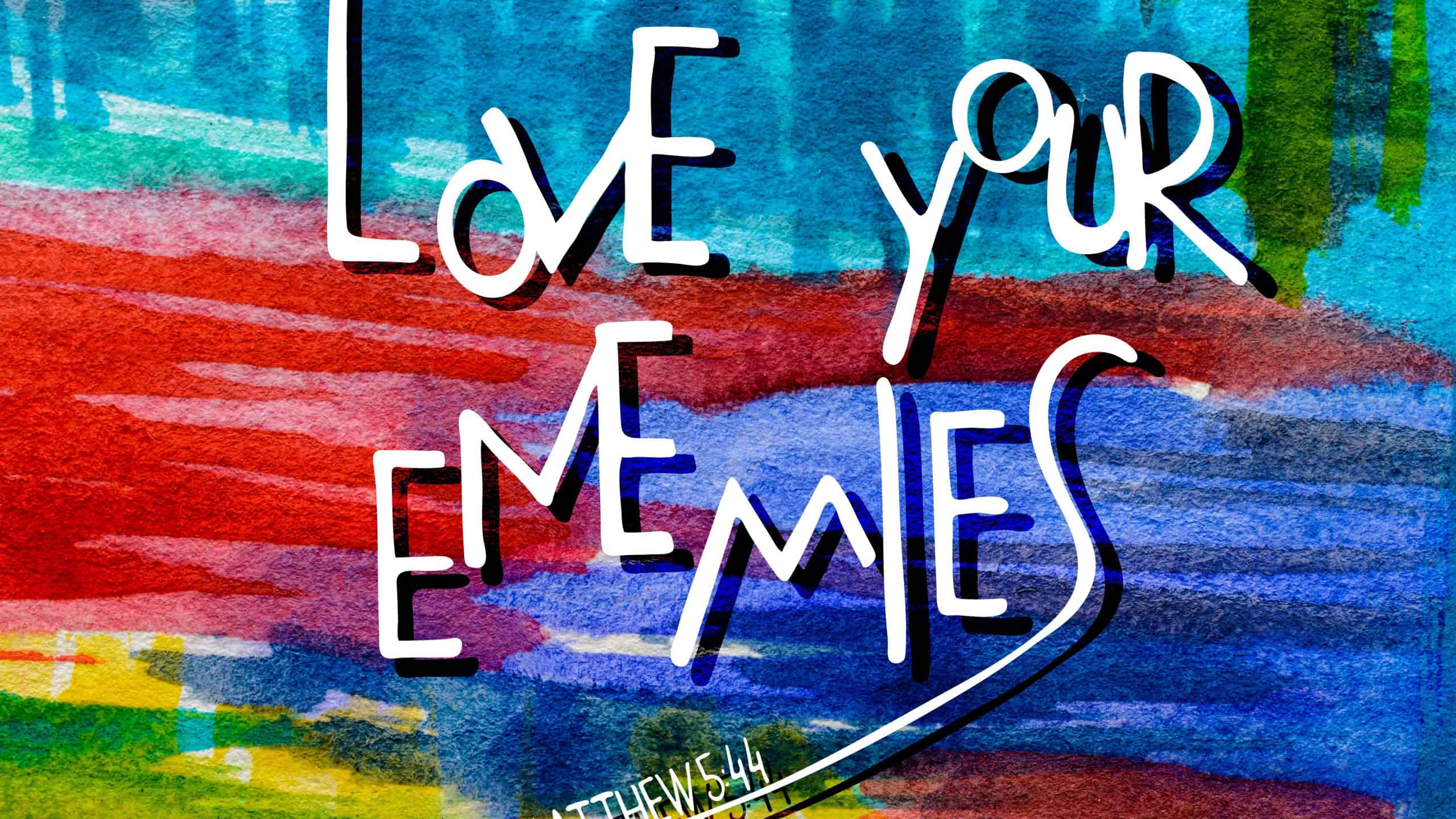 Love your enemies. Inspirational and motivational quote. Modern brush calligraphy. Hand drawing lettering. Abstract watercolor background. Words about God.