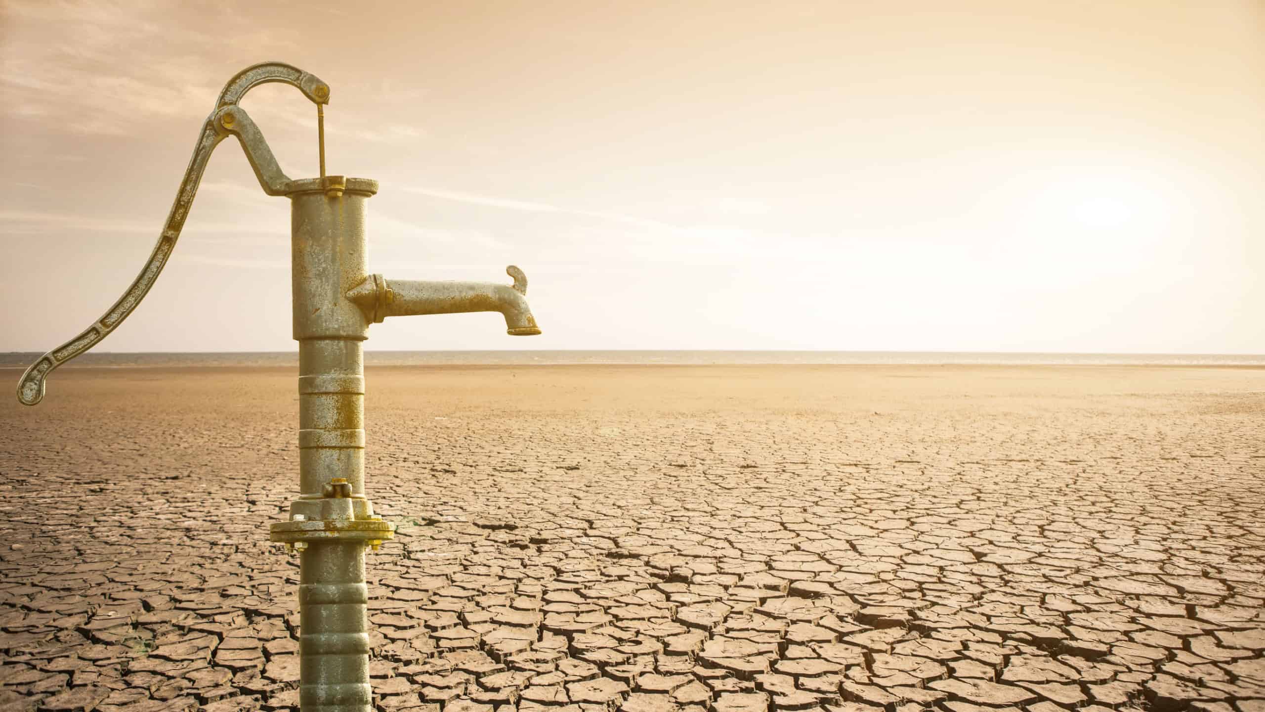 Dry cracked desert with old water pipe