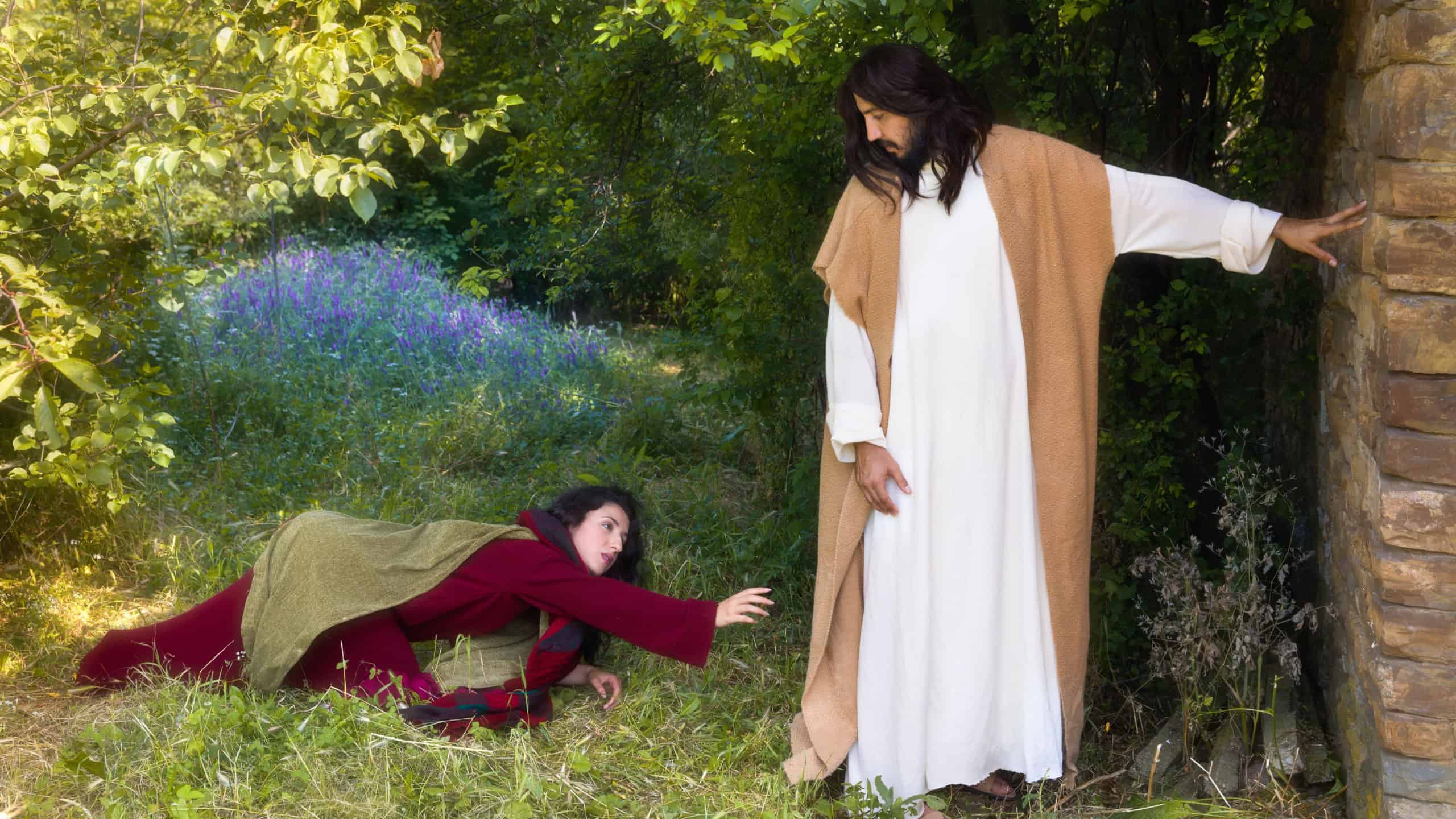 Repentant sinner woman touching the robe of Jesus, asking for forgiveness and healing