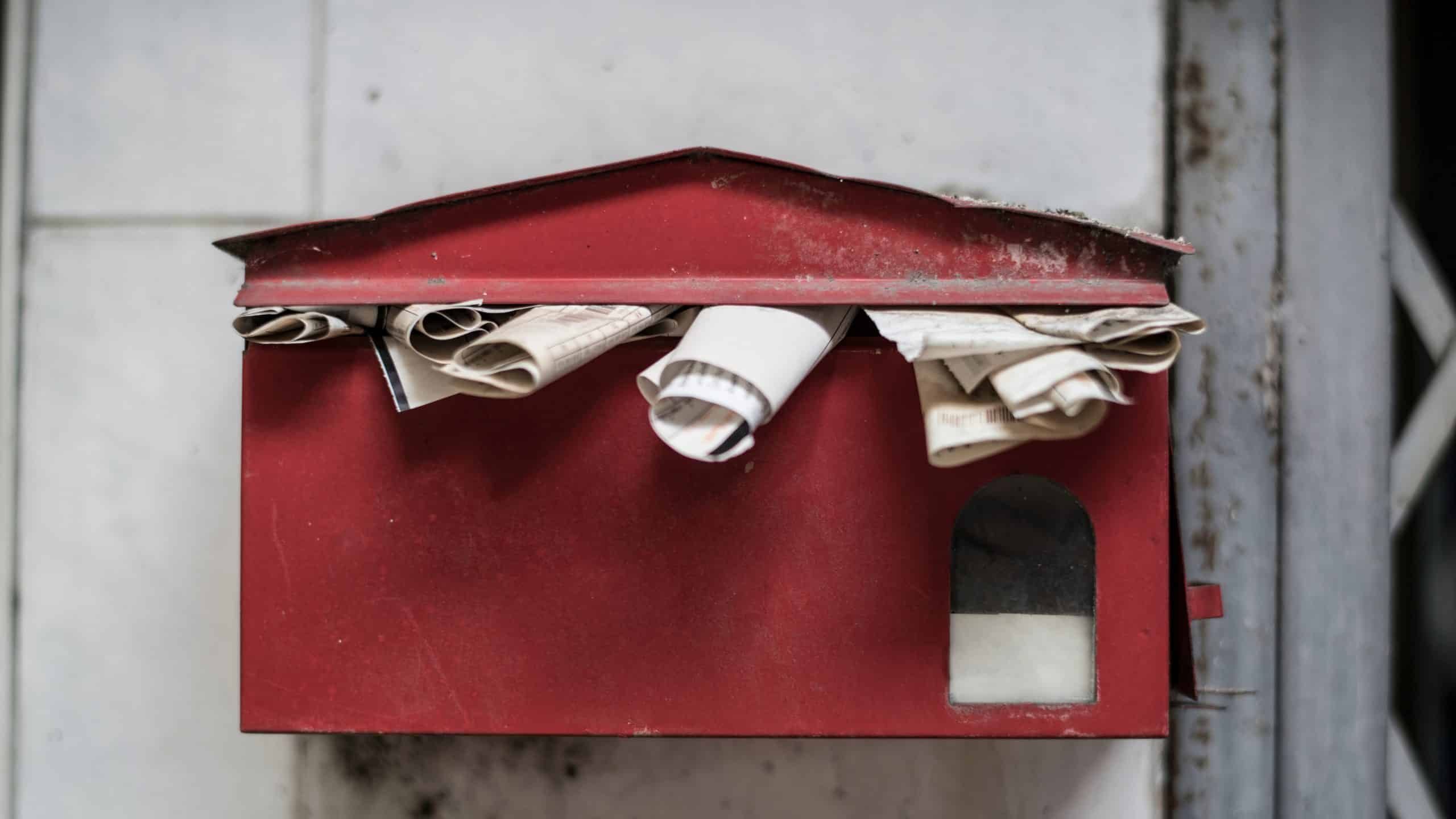 An overfull old post box