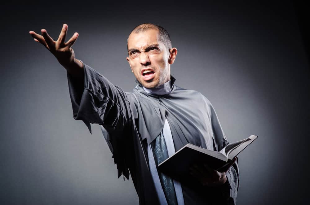 Young priest isolated on the white