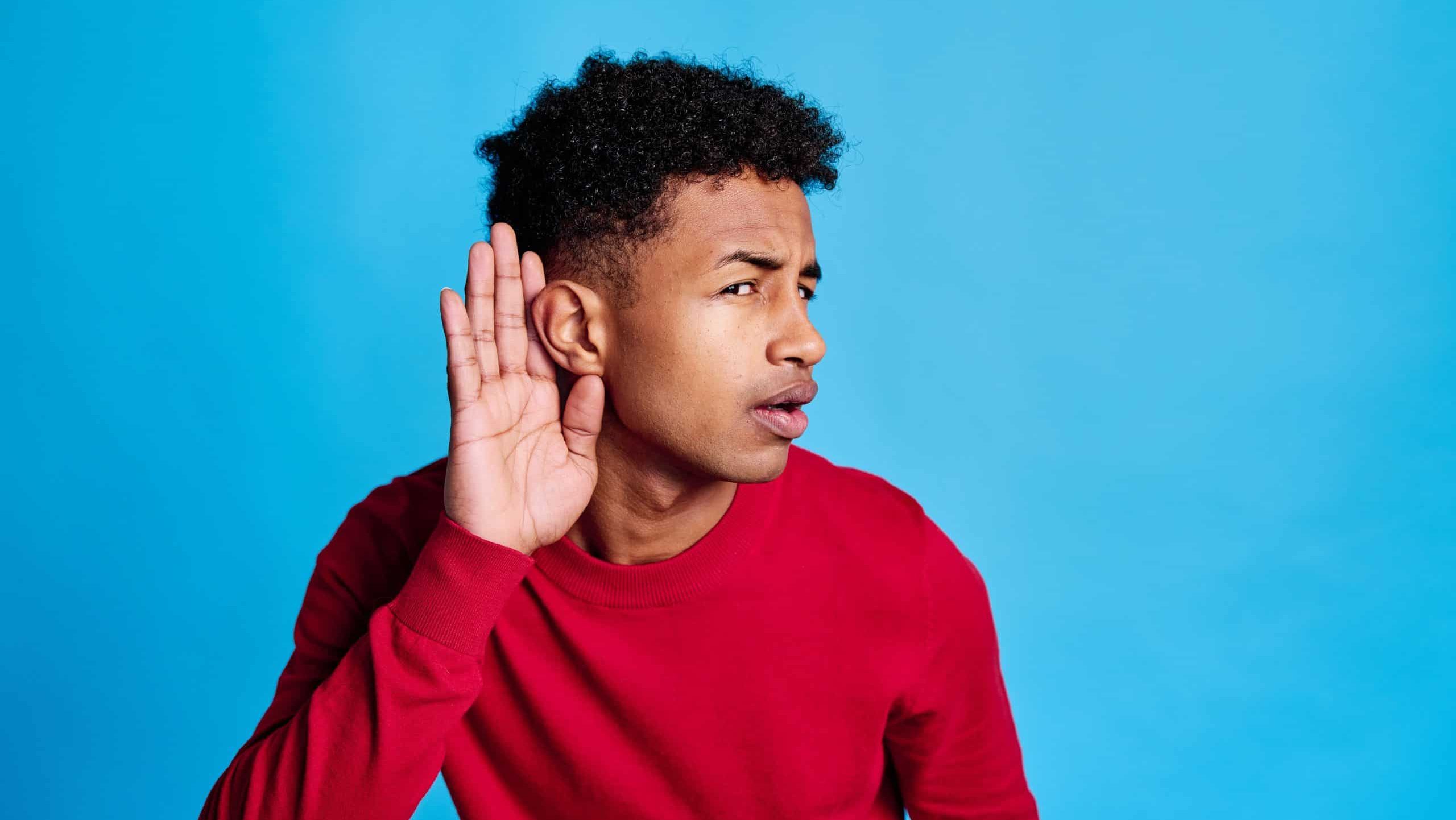 Thoughtful black man touching forehead and listening carefully