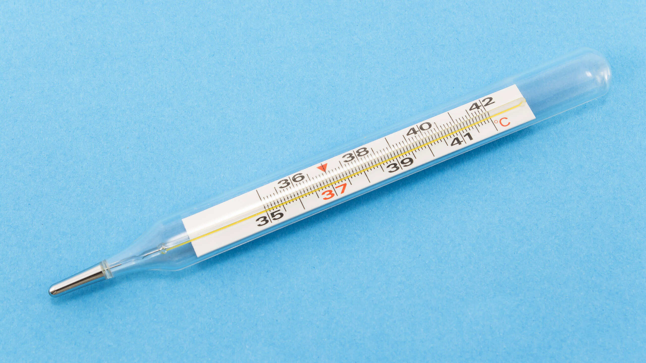 Mercury thermometer isolated on blue.