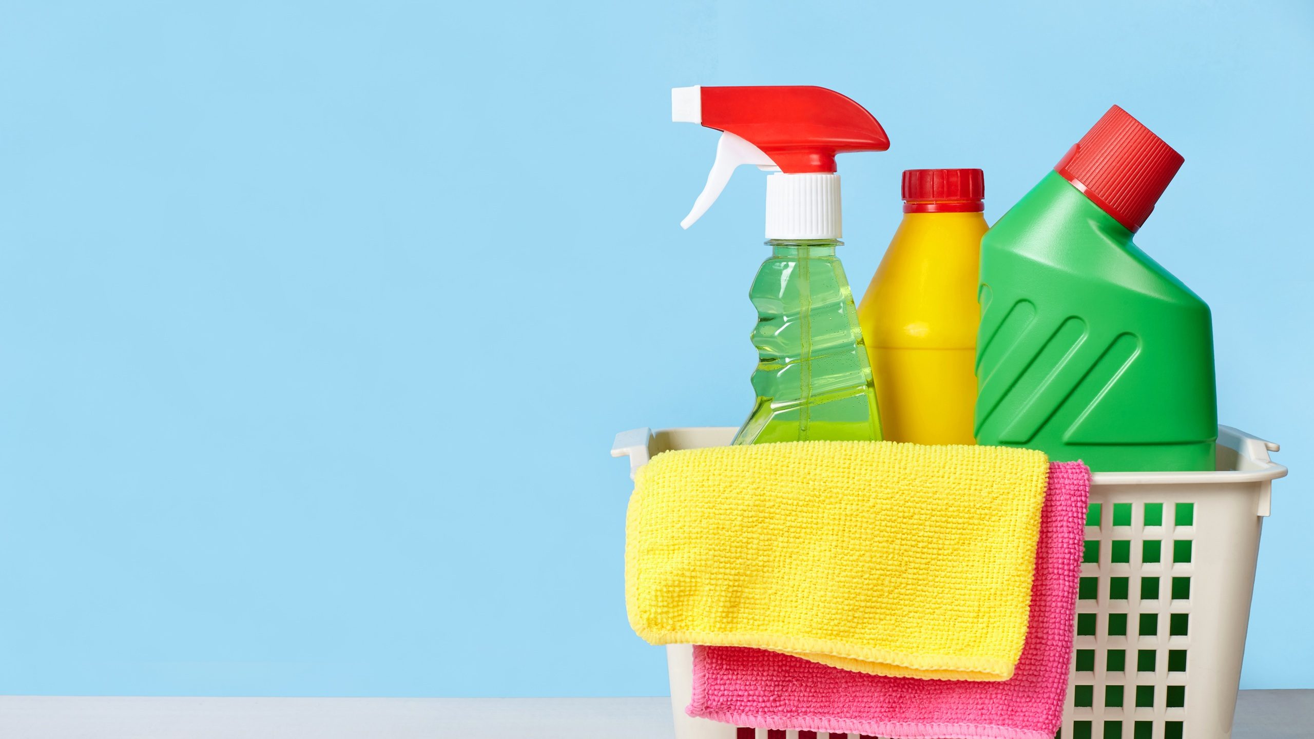 Cleaning concept. Basket with equipment for cleaning. Blue background with copy space.