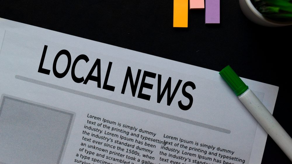 Local News text in headline isolated on Black background. Newspaper concept