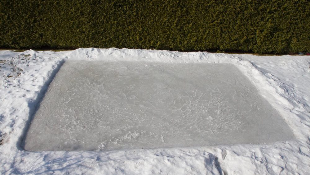 Backyard Ice-skating Rink created on a lawn in winter