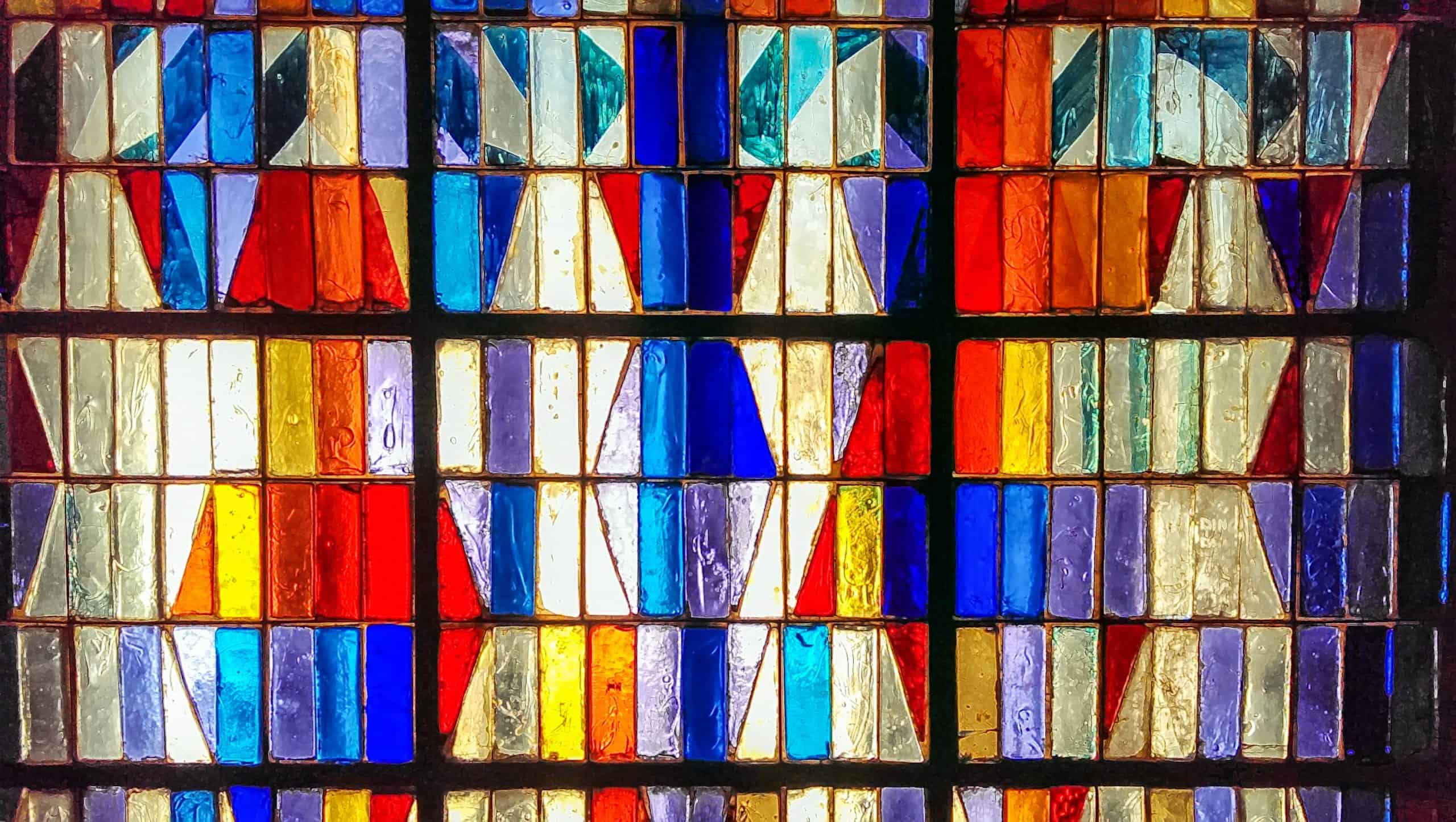 Colorful abstract stained glass background. Medieval random pieces of glass pattern with backlight