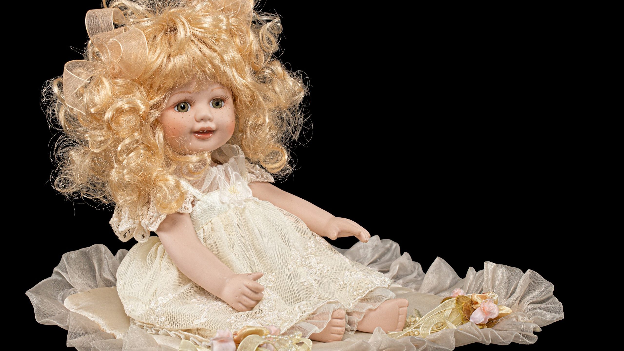 Vintage porcelain doll, isolated on black background