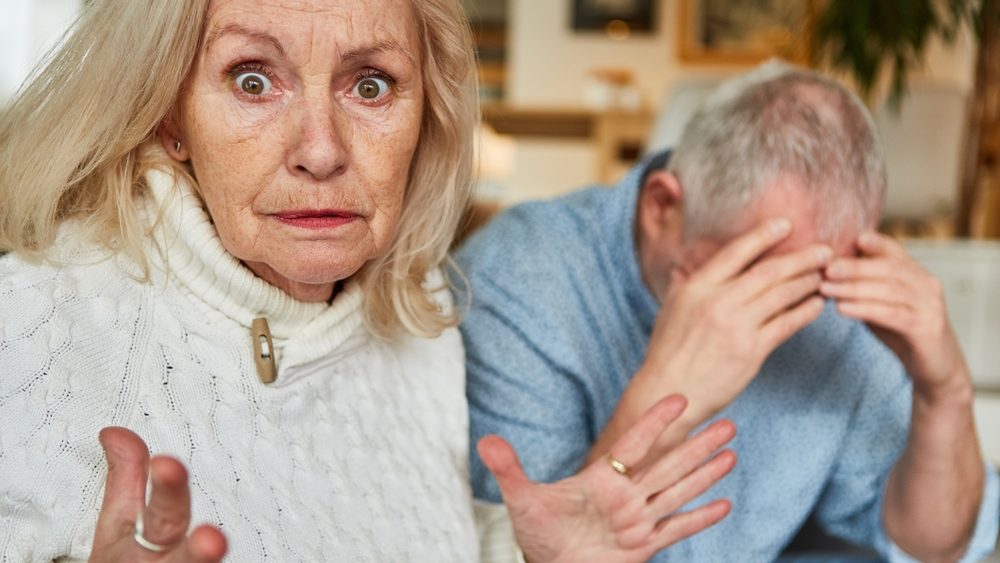 Elderly woman angry quarreling with sad senior for relationship conflict and aggression
