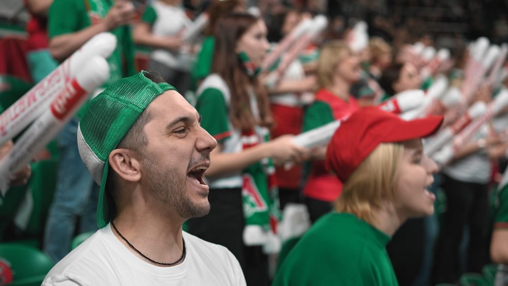 Fans shout football sport stadium event. Guy score goal close up. Crowd applaud tribune. Cap people cheer team win. Man play game cup. Couple wave hands air. Arena stands claps. Fan cheering soccer.