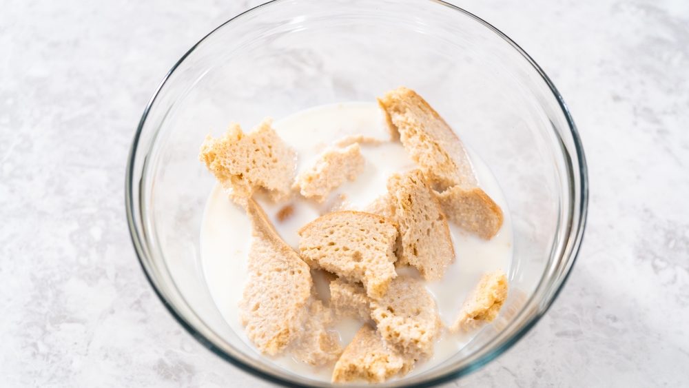 Soaking stale bread in milk to make meatloaf.