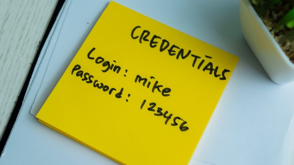 Concept of Credentials, Login and Password write on sticky notes isolated on Wooden Table.