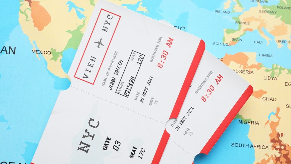 Travel agency. Flight tickets on world map, top view