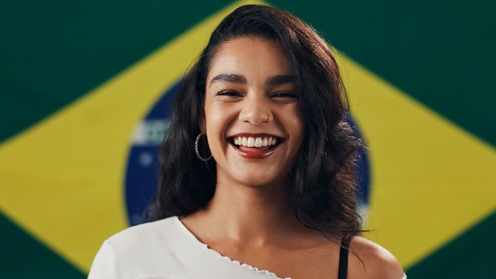 Brazil, happy and portrait of woman with flag for national pride, support and citizenship. Patriot, person and smile with Brazilian banner for symbol of identity, loyalty and culture of independence