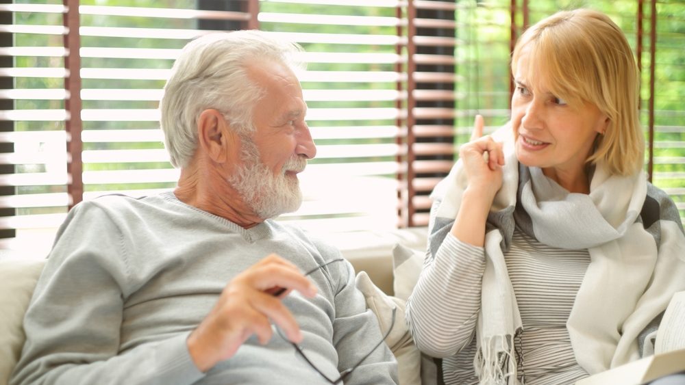 Portrait of middle aged senior couple talking relaxing on comfortable sofa together in living room at home. family relations, taking care concept.