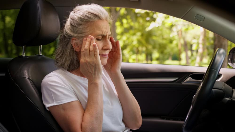 Stressed worried Caucasian suffering aged senior unhealthy woman elderly female automobile driver lady holding head massaging temples suffer headache migraine health problems pressure inside car auto