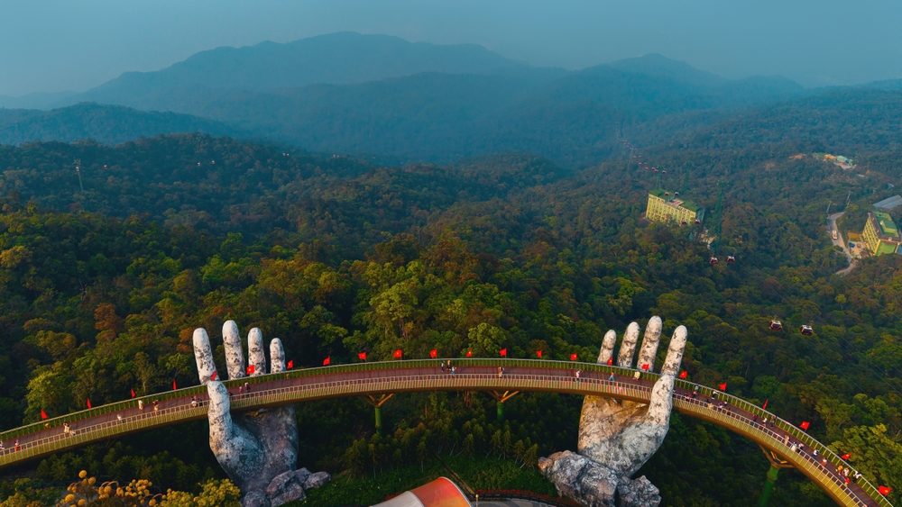 Golden bridge in ba na hills, stunning architectural marvel amidst lush greenery in Vietnam.