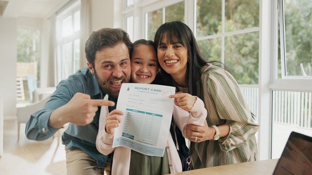 Portrait, school report and parents with child in home for score, good grades and exam results. Pointing, proud family and happy mom, dad and girl with card for education, learning success or support