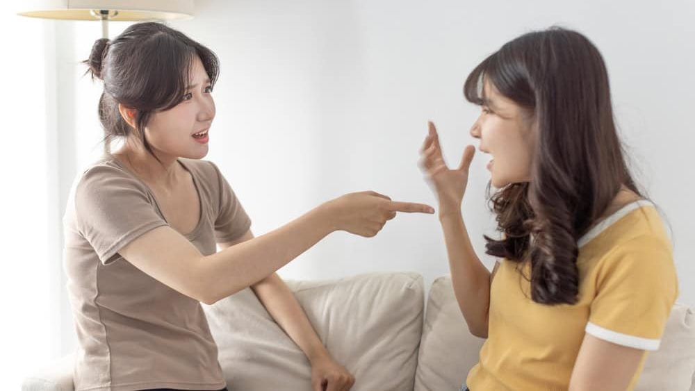 Two girls friends, sisters are fighting, crying, yelling, argue, hurt each other
