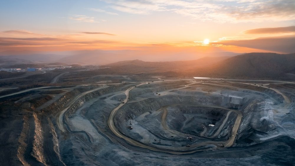 Panoramic of open pit mine industry, aerial view. Big yellow mining truck for coal working in quarry.