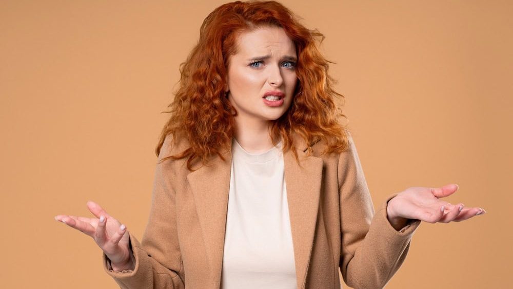 Confused Woman Shrugs Shoulders Showing Uncertainty, Confusion, Hesitation