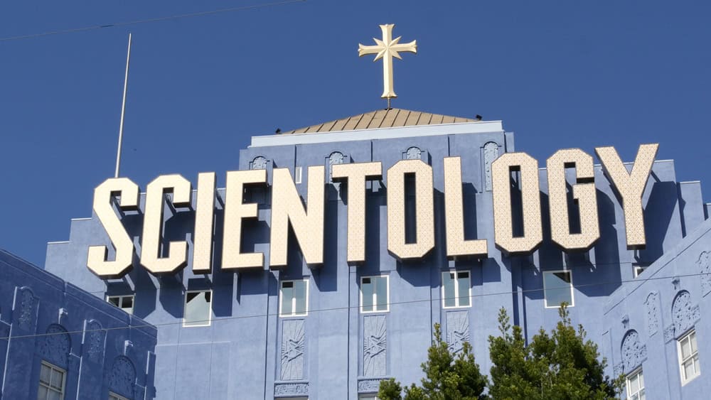 Los Angeles, California USA - 24 Feb 2020: Church of Scientology exterior, facade of blue building near American Saint Hill Organization in Hollywood. Logo and cross. International religious movement.