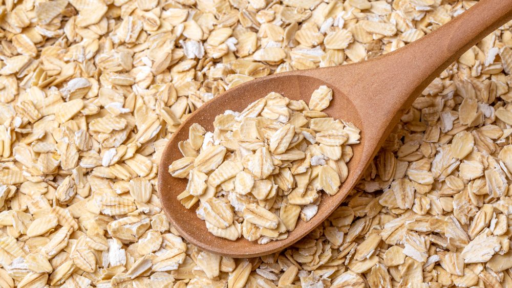 Heap of dry rolled oats isolated 