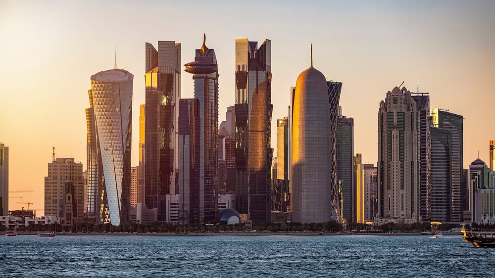 Closeup view of the modern skyline of Doha, Qatar, with the skyscrapers shining in sunset light