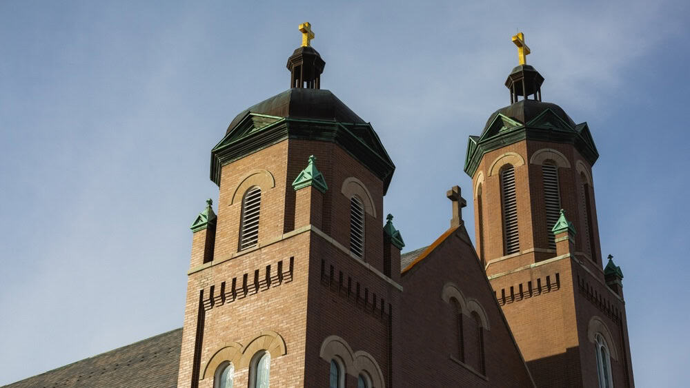Plymouth, Indiana - February 19, 2021: Towers and crosses at a Catholic church, downtown.