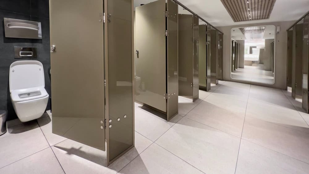 public toilet, Row of public toilet or restroom doors in a hotel or office or shopping mall. clean loo or wc interior. Open doors of public toilet stall. bathroom are partitioned into rooms