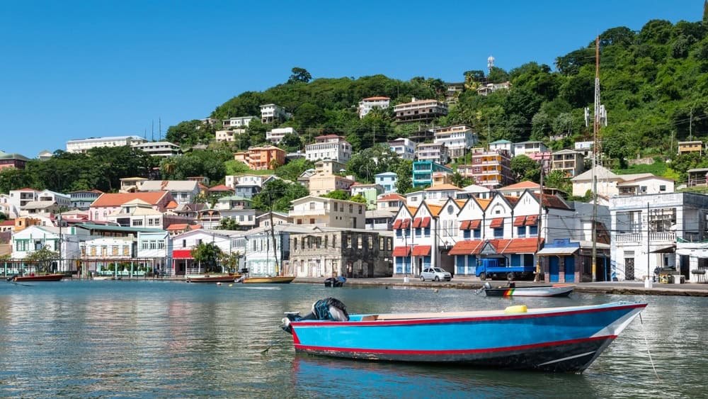 Inner harbor of St George's, Grenada, Caribbean. Blue boat in the bay.