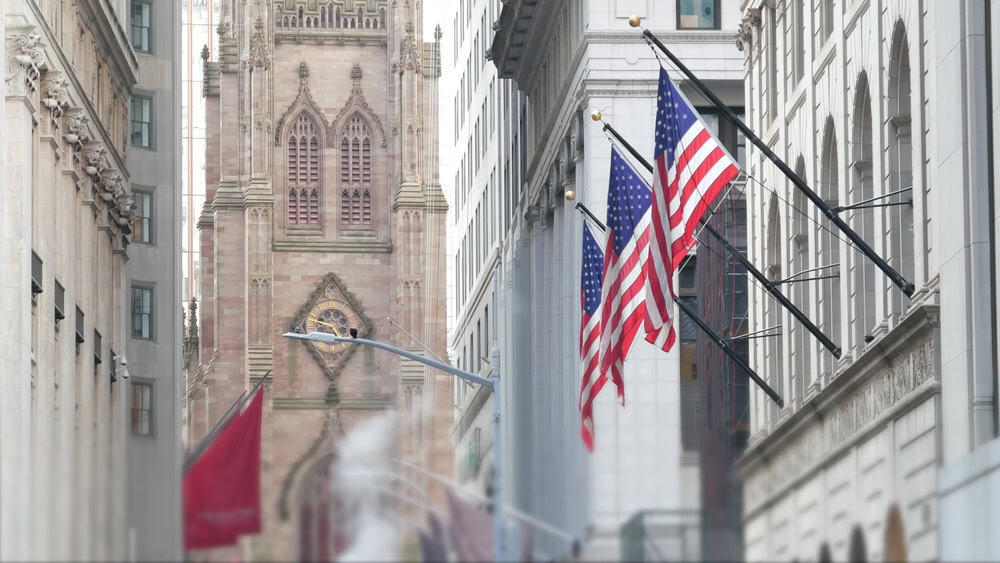 New York City United States. Lower Manhattan Downtown Financial District urban architecture. American Flag, Trinity Church. Wall street Stock Exchange building, USA Stock Market. Hot steam smoke stack