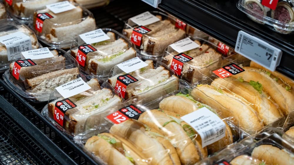Colorful Assortment of Donuts and Pastries Displayed on Shelves, Freshly Baked Donuts and Sweet Treats in Protective Packaging on Display