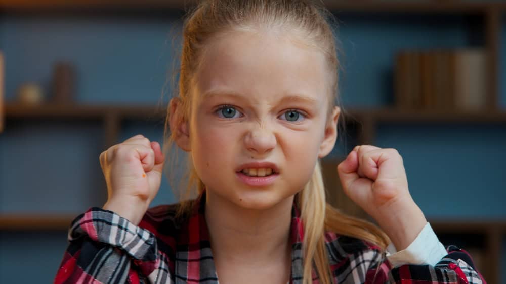 Portrait at home furious angry child kid girl little annoyed irritated daughter in evening home looking at camera stressed mad reaction bad news teen pupil feeling anger dissatisfied childhood problem