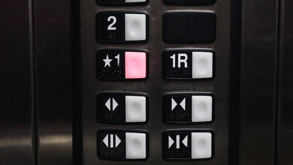 Elevator control panel closeup. Floor selection buttons inside lift. Modern building interior detail. Transportation technology concept. Vertical mobility system indoors. Public infrastructure design.