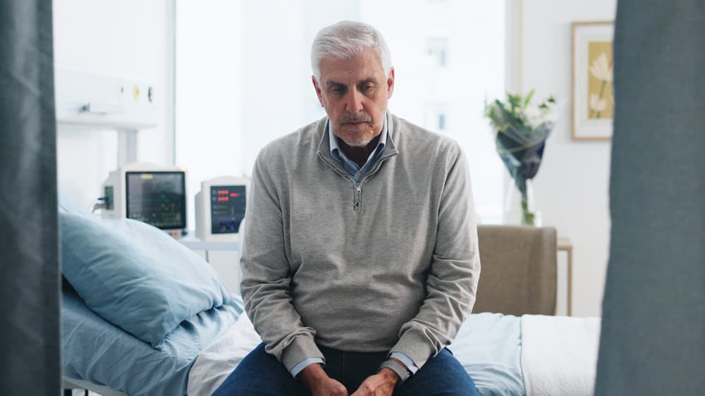 Medical, upset or old man on hospital bed with thinking, appointment stress or waiting for surgery result. Healthcare, anxiety or elderly patient with fear, reflection or diagnosis worry in checkup.