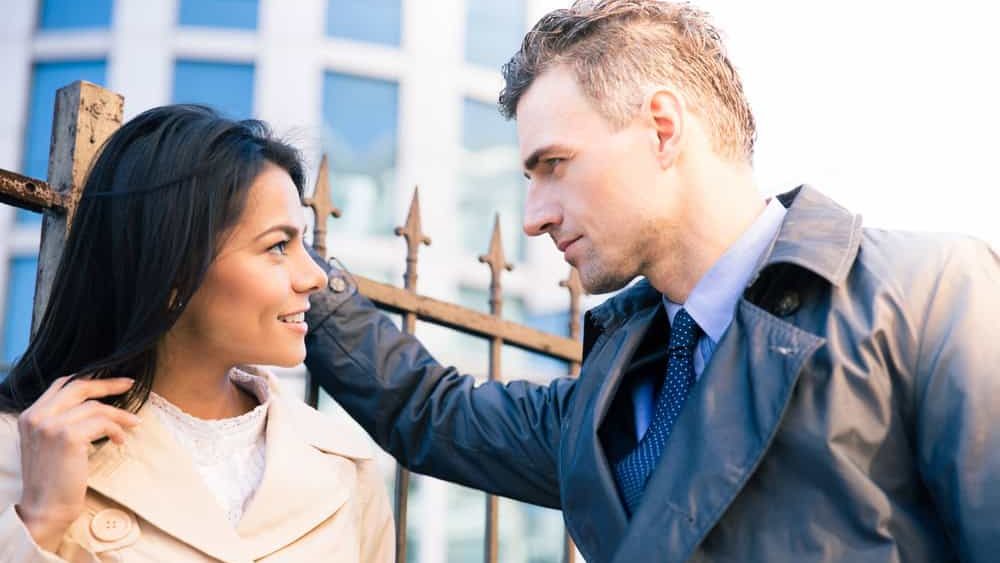 Beautiful woman and handsome man flirting outdoors