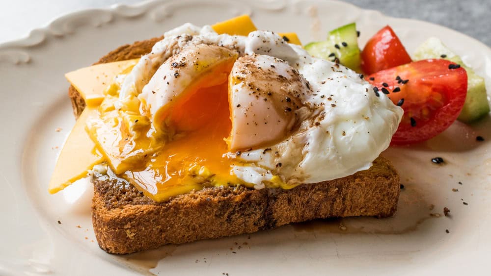 Poached Egg on Toast Bread with Cheddar Cheese, Balsamic Vinegar, Salad and Black Sesame or Cumin Seeds