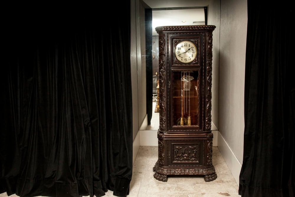 An old grandfather clock on a fancy room.