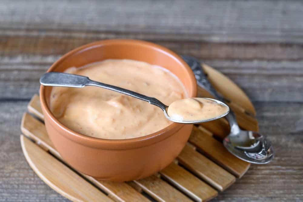 Bowl of Thousand Island dressing on wooden table