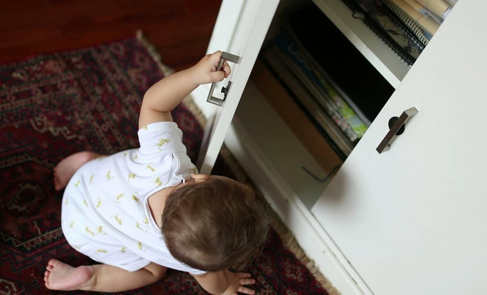 Baby toddler opening drawer cabinet
