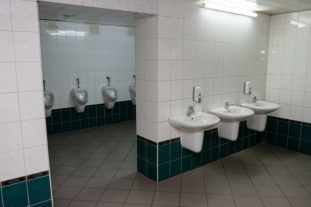 Public restroom with sinks and urinals in a tiled area