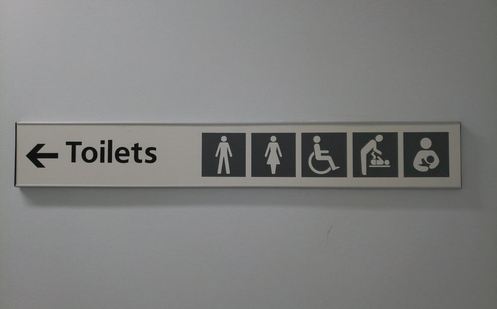 Toilet sign in a hospital against a white background